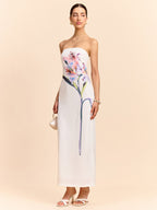 A strapless maxi dress featuring an elegant floral design from LA FINE FLEUR.
