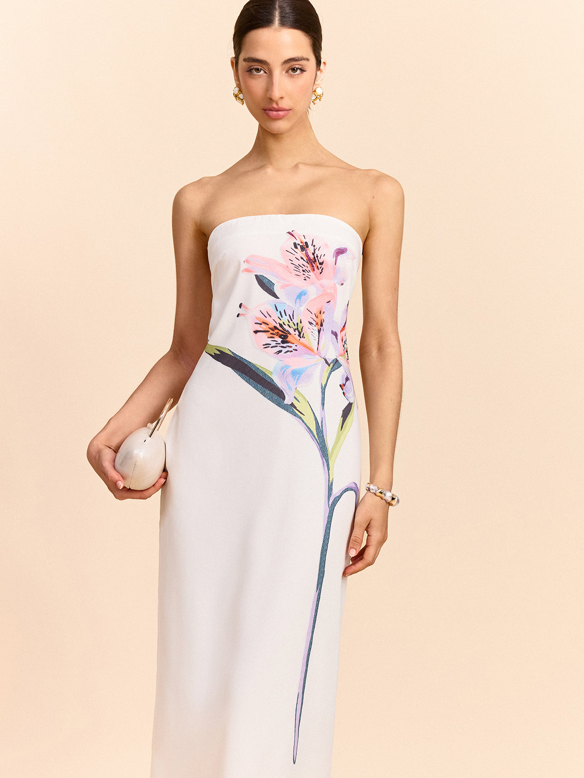 A strapless maxi dress with an elegant floral design from LA FINE FLEUR.