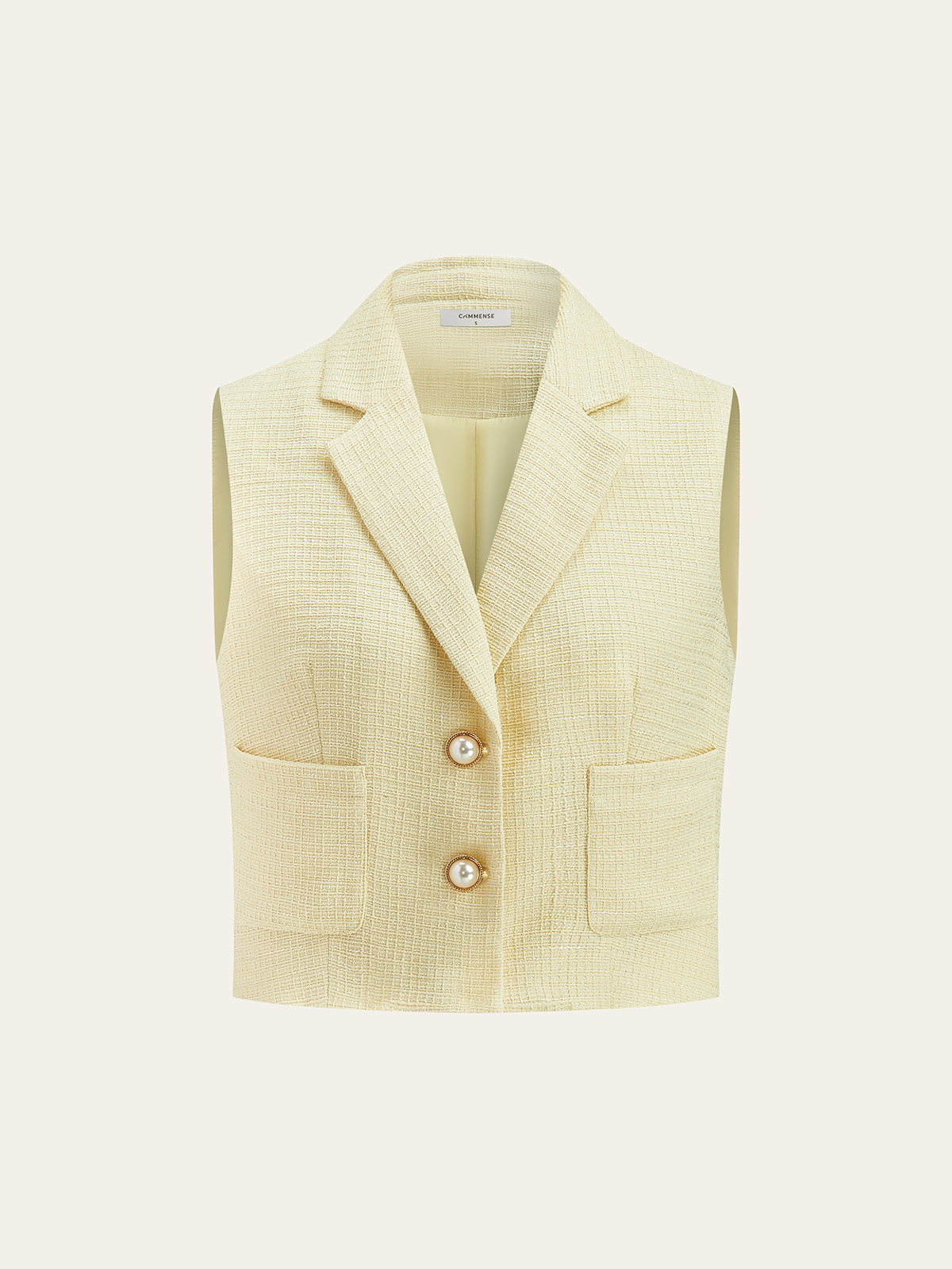 Sleeveless, light yellow tweed vest and matching shorts with notched collar and pearl buttons.