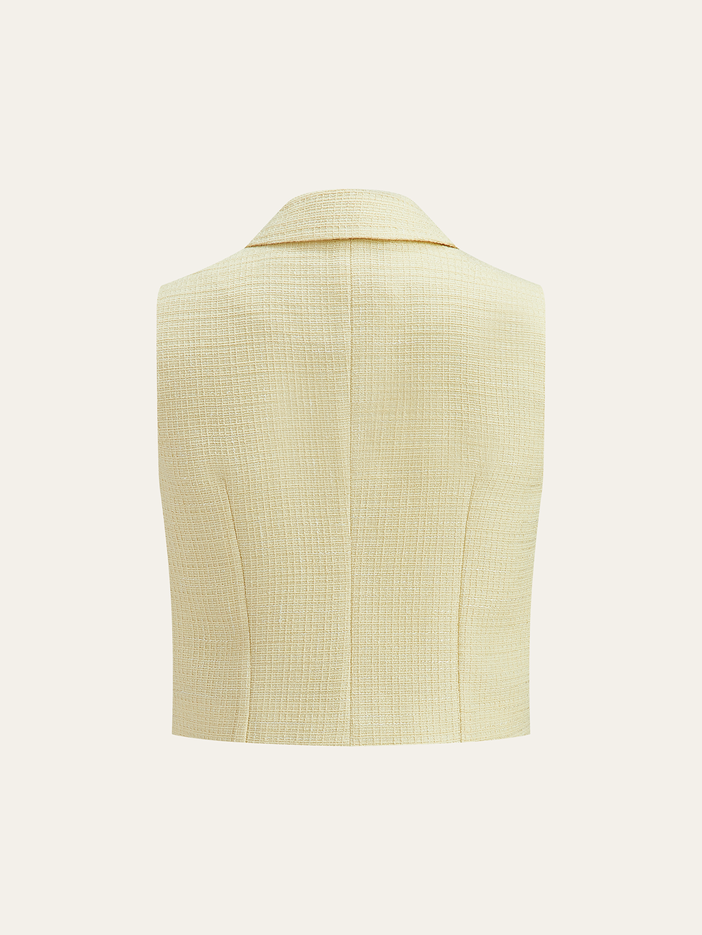 Cropped sleeveless pale yellow tweed vest with grid texture, small collar, pearl buttons.