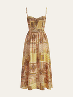 Midi dress with spaghetti straps, smocked bodice, yellow-brown-pink patchwork, geometric and paisley patterns.