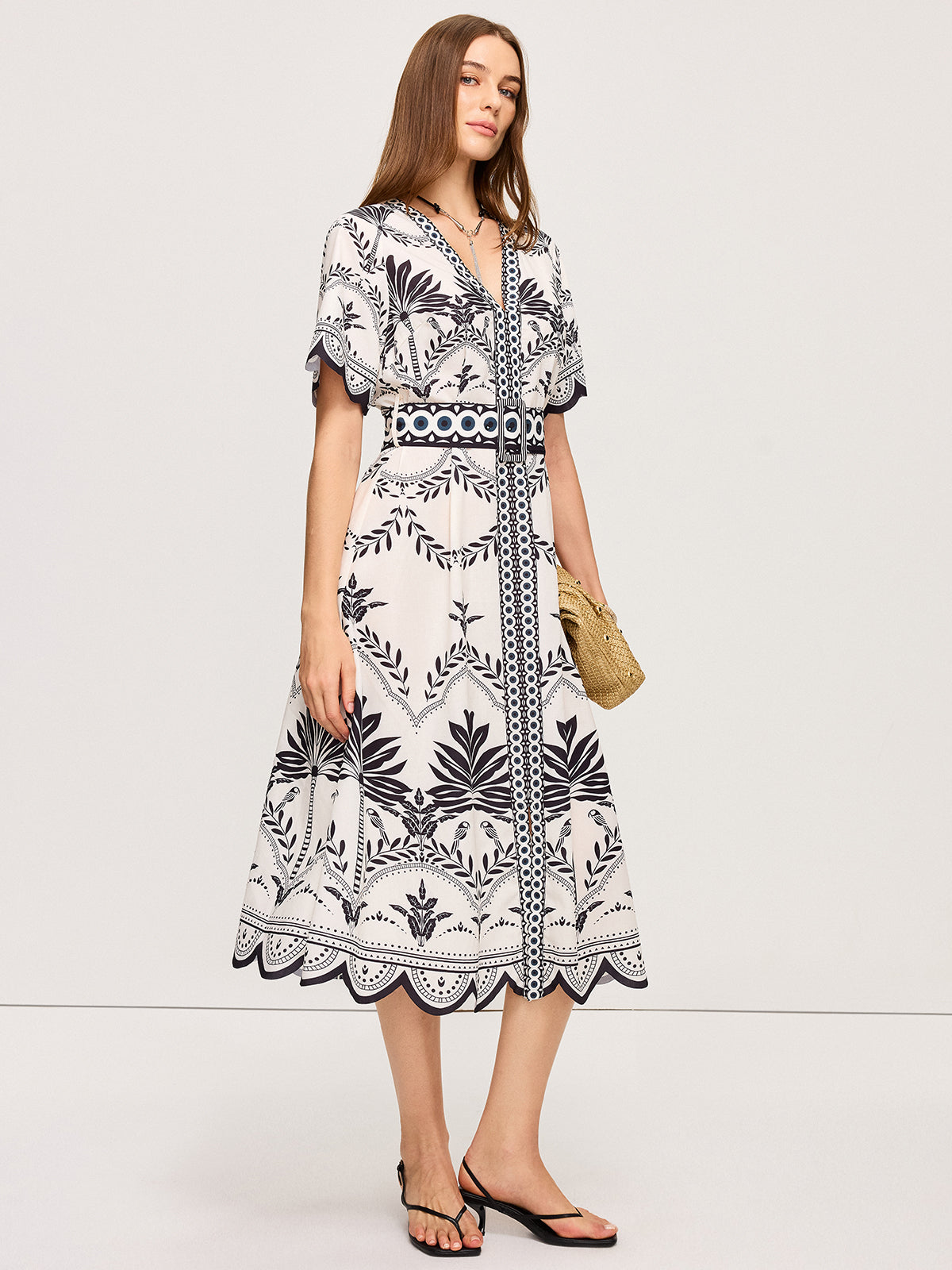 A black floral-patterned, Bohemian V-neck midi dress with a casual, relaxed fit.