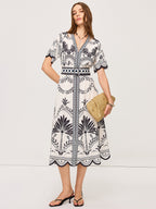 Bohemian Floral V-Neck Midi Dress with black floral and geometric patterns, belted waist.