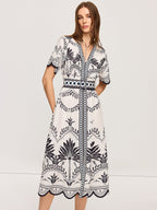 LA FINE FLEUR Bohemian Floral V-Neck Midi Dress with black botanical print and matching belt.