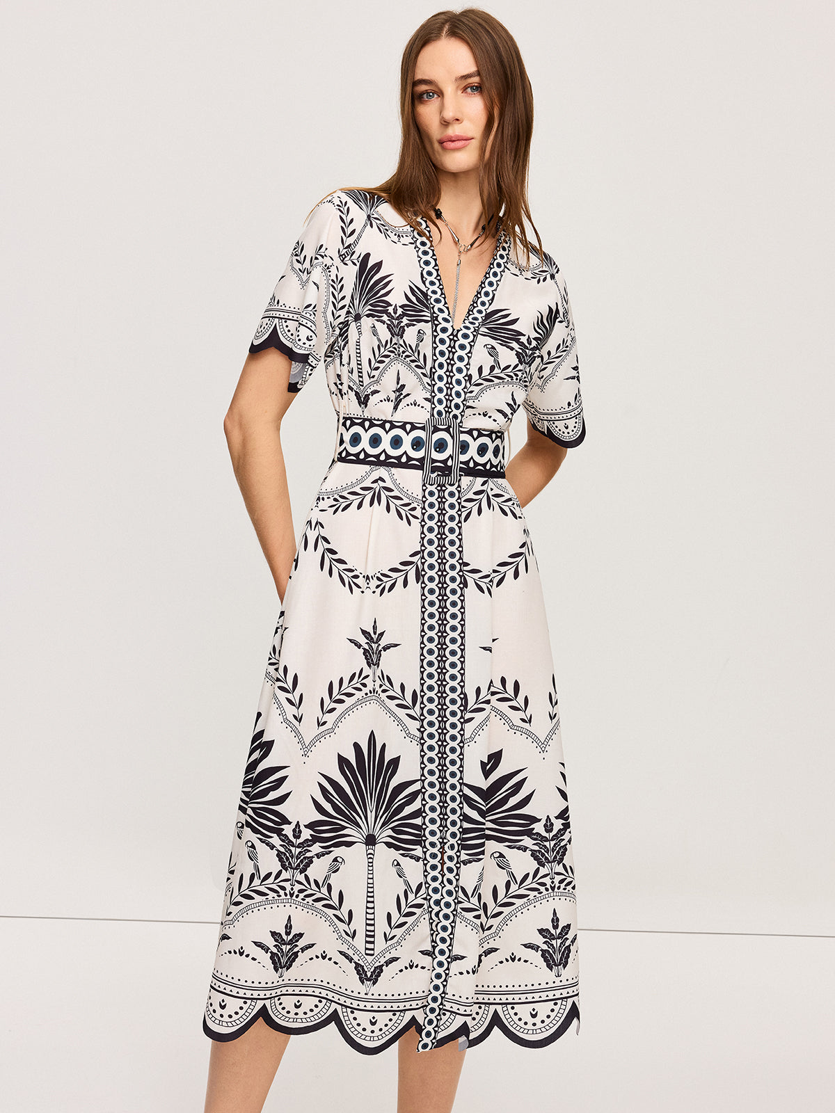 LA FINE FLEUR Bohemian Floral V-Neck Midi Dress with black botanical print and matching belt.