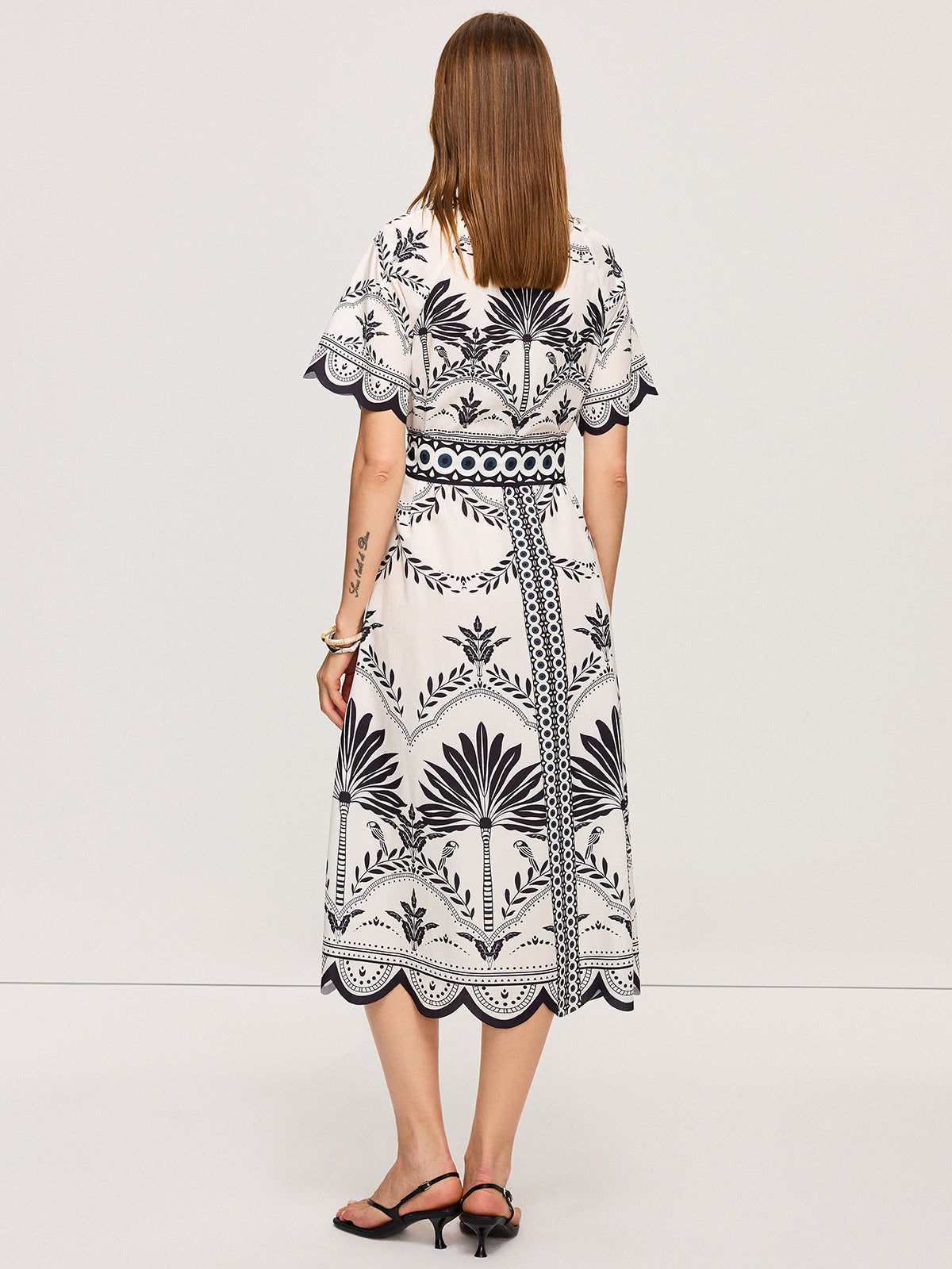 LA FINE FLEUR white bohemian floral V-neck midi dress with black palm tree and bird prints.