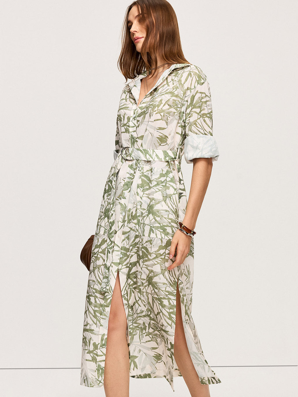 LA FINE FLEUR Leaf Print Belted Midi Dress with rolled sleeves and side slits.