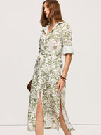 LA FINE FLEUR Leaf Print Belted Midi Dress with rolled sleeves and side slits.