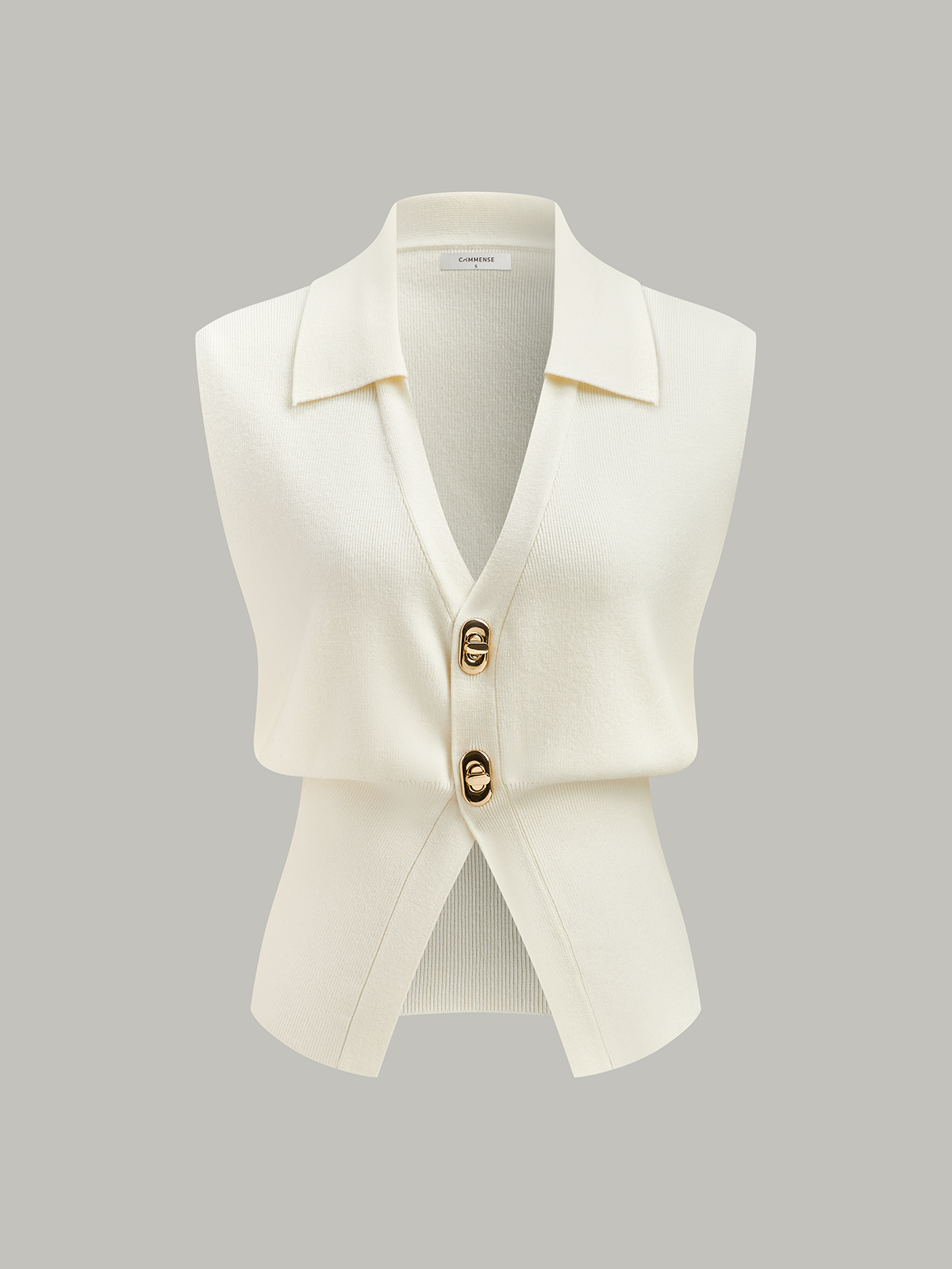 Sleeveless cream textured knit vest with collar and two large metallic buttons.