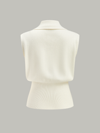 Sleeveless cream knitted vest with metallic buttons, collared, ribbed waist, textured knit detailing.