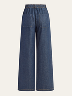 Mid-rise dark blue denim trousers with a wide-leg cut, elastic waist, and square back pockets.