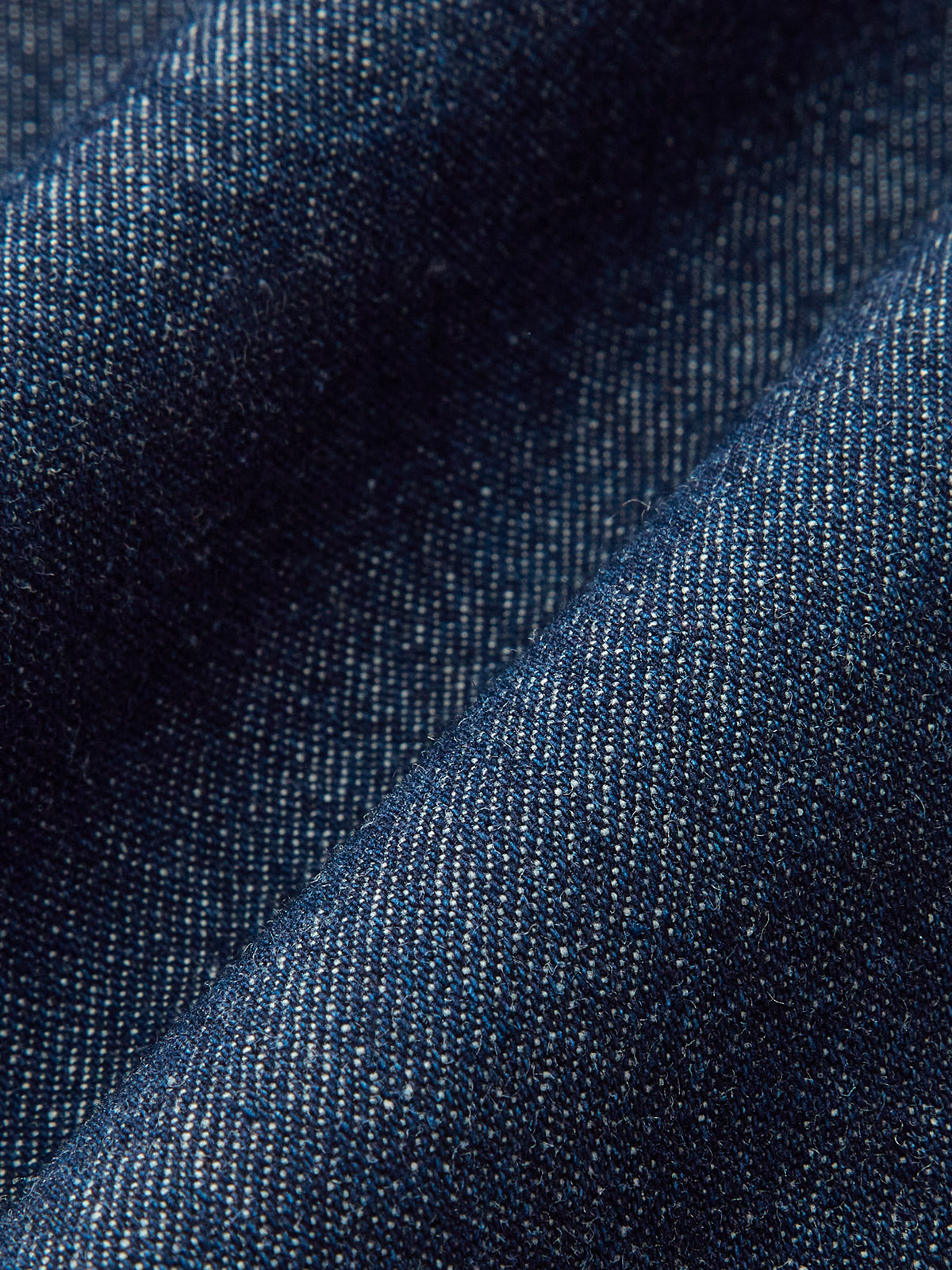 Textured blue denim wide-leg trousers with gentle folds and subtle tones for a relaxed fit.