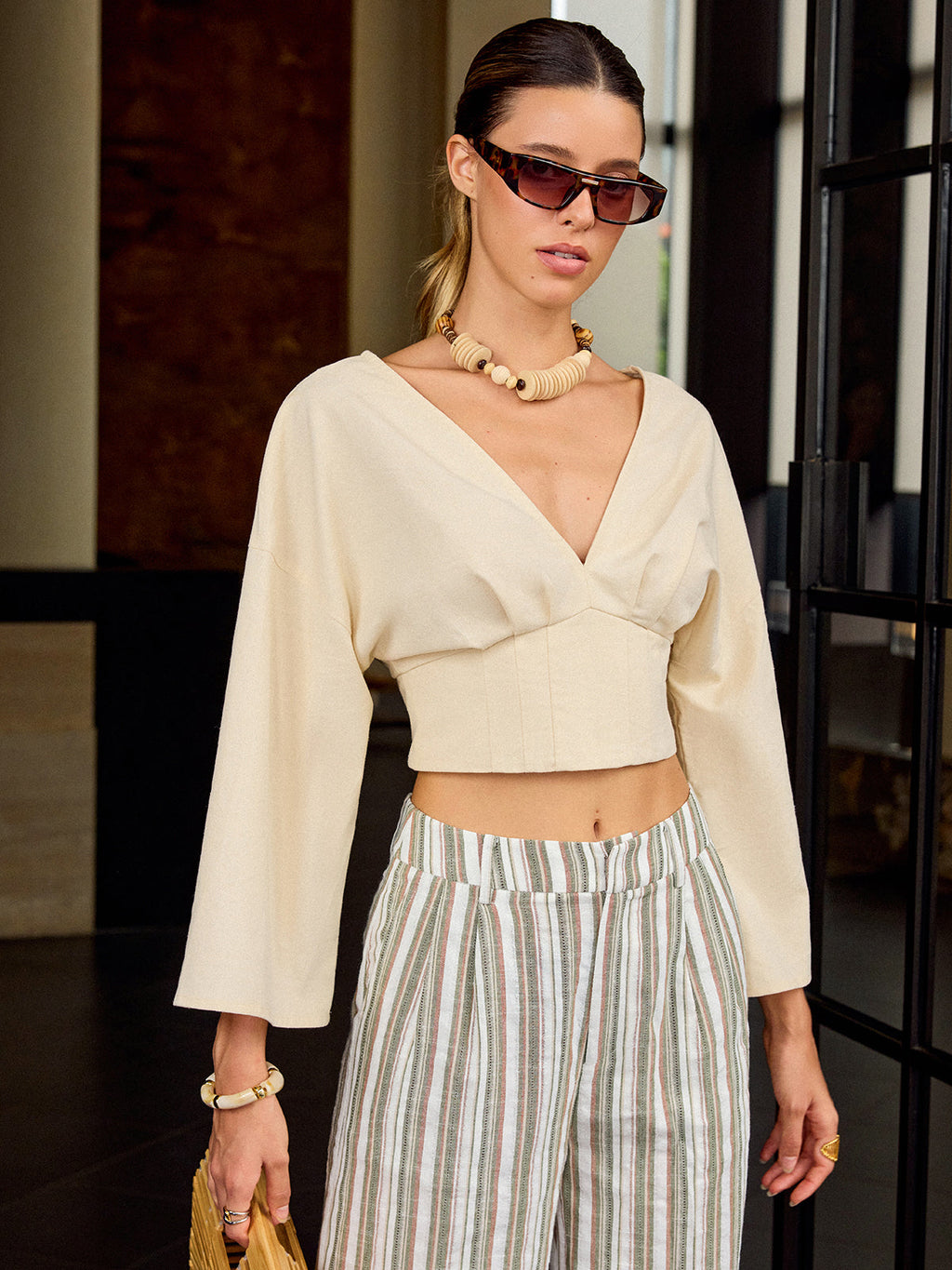 Slim fit V-neck cropped tee paired with striped high-waisted pants—casual and stylish.