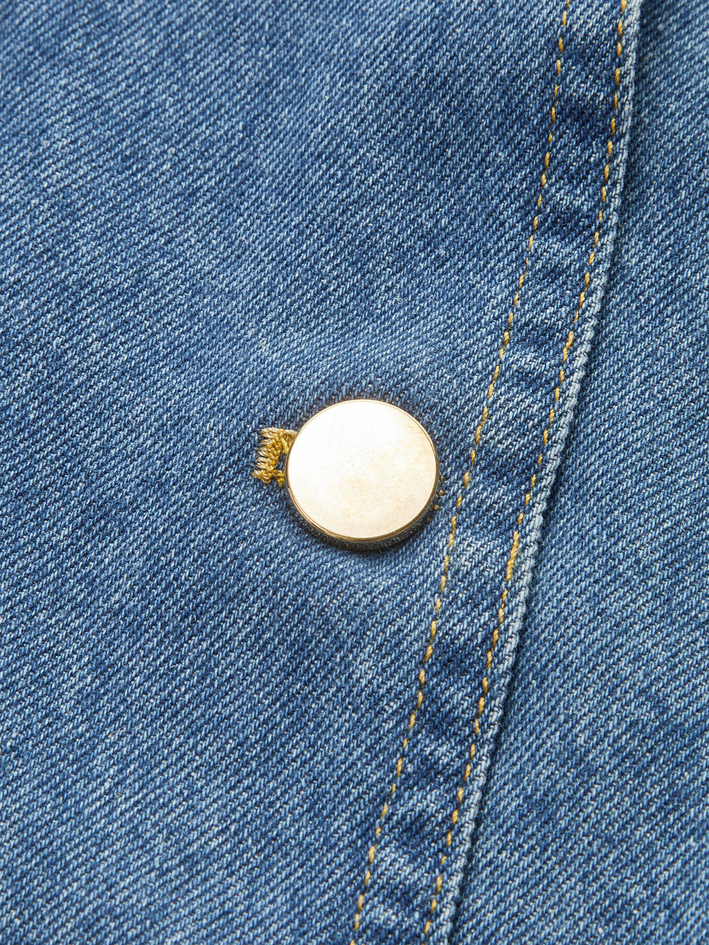 Classic denim vest with yellow stitching, gold button detail, and polyester fabric construction.