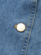 Classic denim vest with yellow stitching, gold button detail, and polyester fabric construction.