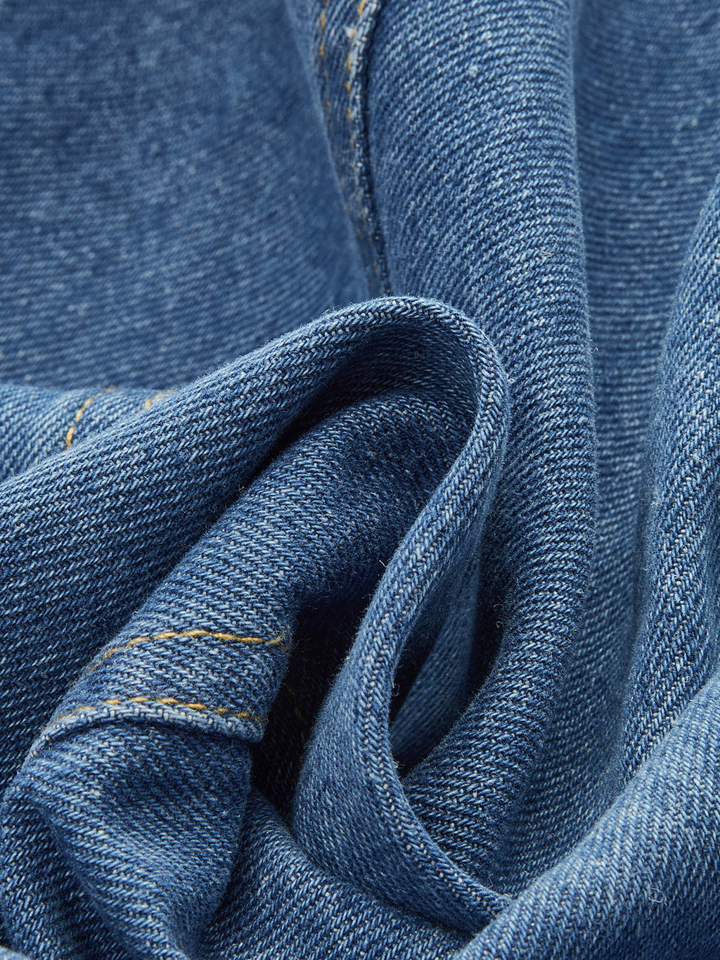 Classic Denim Vest with button closure, blue polyester denim, yellow stitching, textured woven patterns.