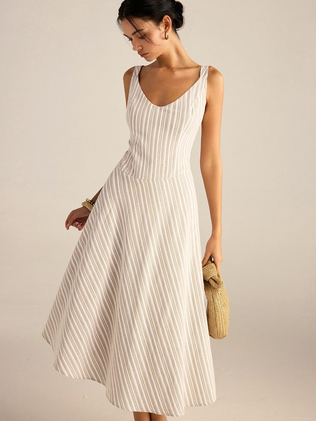 A striped asymmetrical hemline midi dress from LA FINE FLEUR, featuring soft flowing fabric.