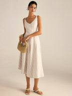 A beige and white striped midi dress with asymmetrical hemline and regular fit.