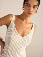Beige and white striped midi dress with an asymmetrical hemline from LA FINE FLEUR.