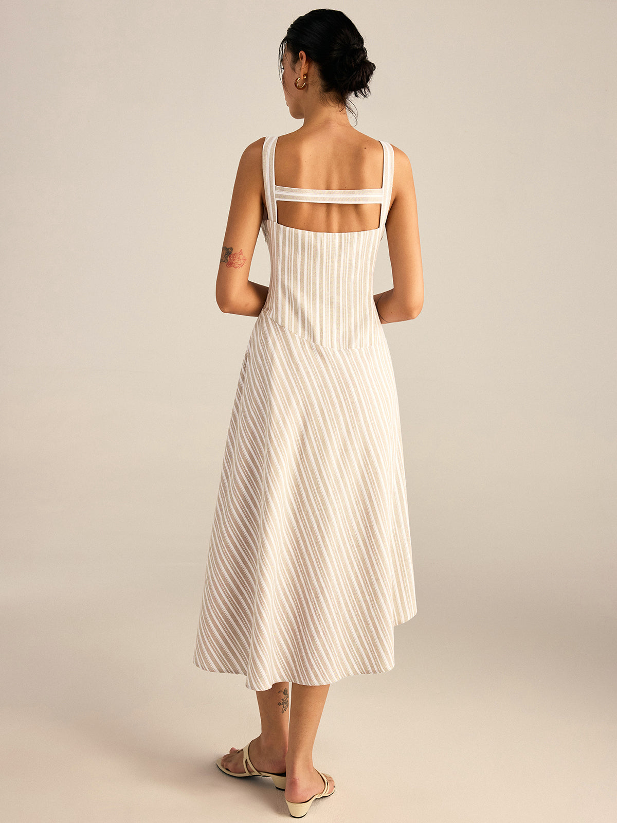 Cream midi dress with thin vertical stripes, square neckline, asymmetrical hemline, cotton-polyester blend.