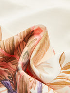 Mid-waist shorts in soft white fabric with pink, peach, and brown floral prints.