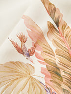 Mid-waist shorts featuring a tropical belt and watercolor botanical prints with leaves and bird.