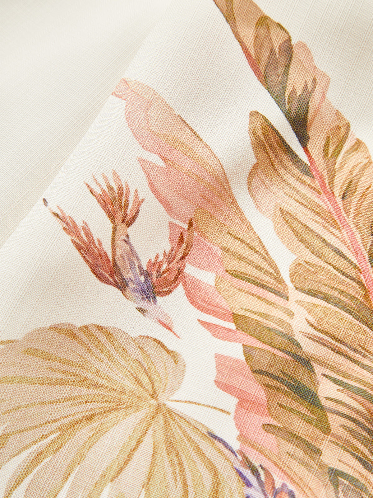 Mid-waist shorts featuring a tropical belt and watercolor botanical prints with leaves and bird.