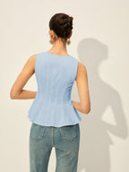 Light blue square neckline buttoned peplum blouse and high-waisted blue jeans ensemble.