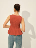 A BYPINKYPARIS square neckline buttoned peplum blouse paired with high-waisted blue jeans.