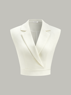 Ivory-white sleeveless cropped blazer vest with wide lapels, deep V-neckline, and cinched waist.