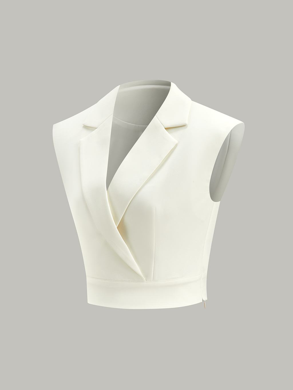 A white sleeveless cropped blazer vest with lapels, deep V-neck, cinched waist, hidden zipper.