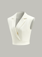 A white sleeveless cropped blazer vest with lapels, deep V-neck, cinched waist, hidden zipper.