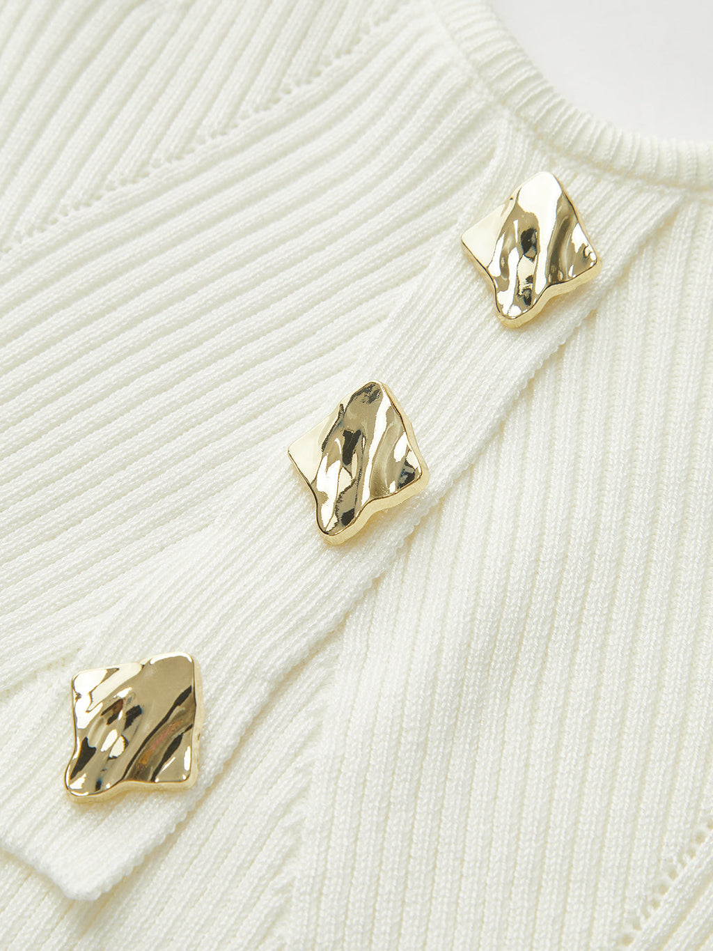 Ribbed knit cami top with three shiny, irregular gold buttons on the front.