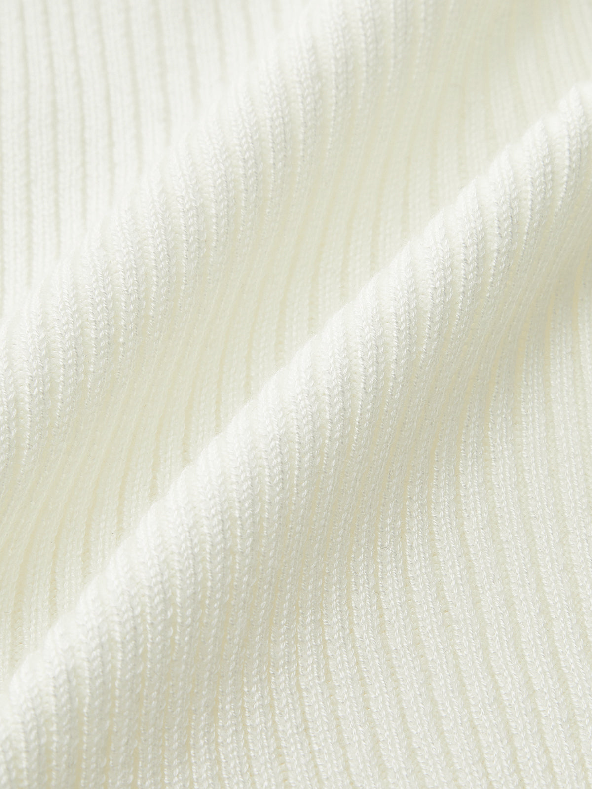 Ribbed knit cami top in soft white with metal button detail and sleeveless v-neck.