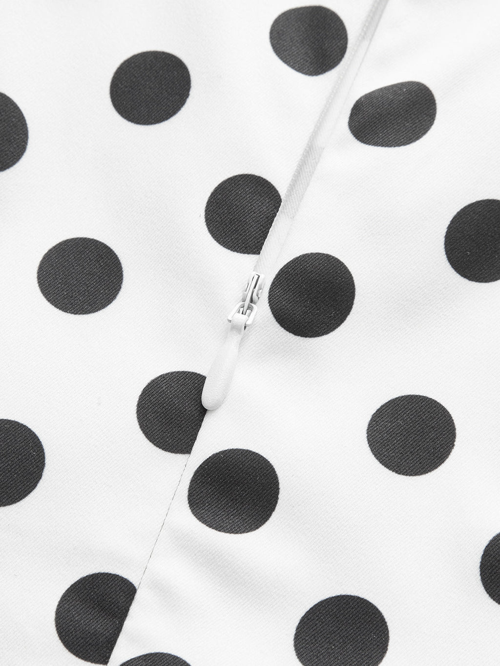 White midi sleeveless dress in polyester with black polka dots and central white zipper.