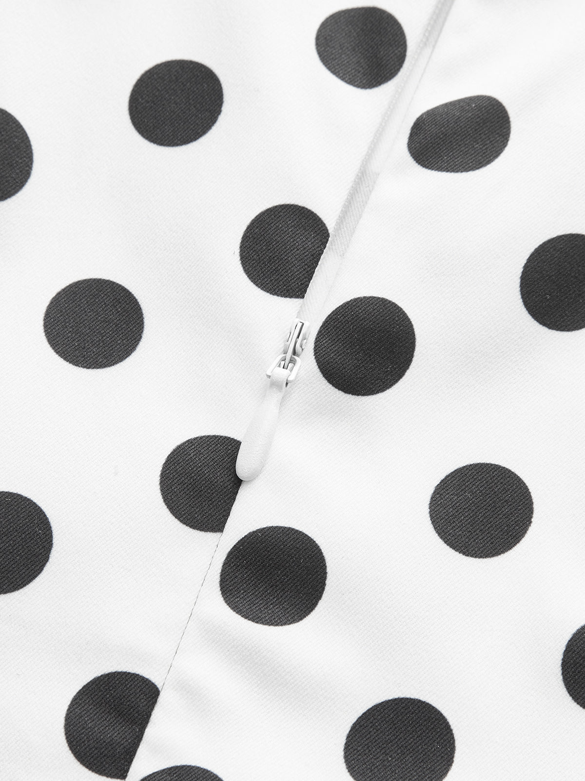 White midi sleeveless dress in polyester with black polka dots and central white zipper.
