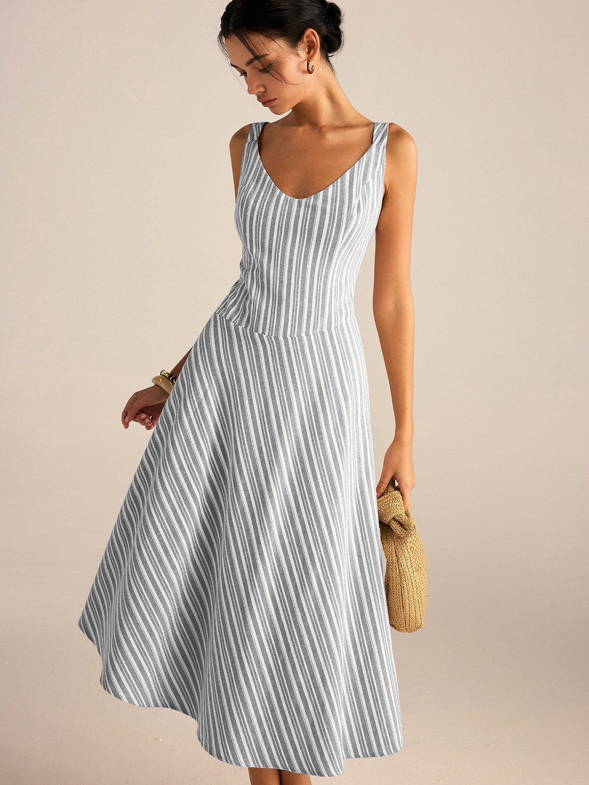 A light blue and white striped midi dress with an asymmetrical hemline.