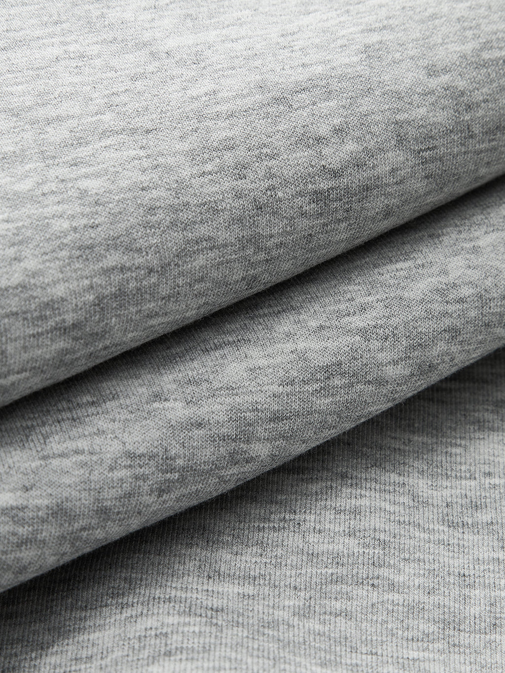 Soft, smooth light gray heathered sweatshirt fabric layers, ideal for crew neck sweatshirts.