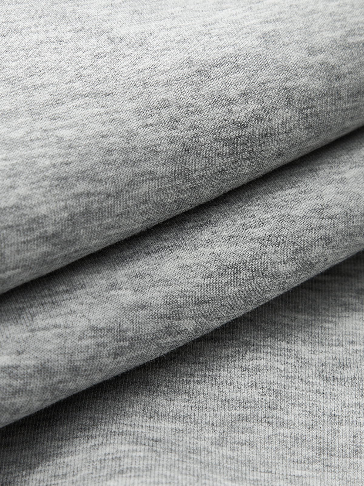 Soft, smooth light gray heathered sweatshirt fabric layers, ideal for crew neck sweatshirts.