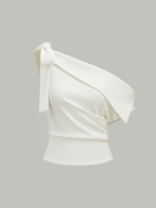 White, sleeveless one-shoulder blouse with asymmetrical neckline and a large bow accent.