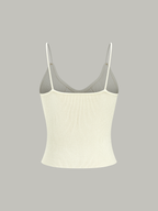 Sleeveless light beige ribbed knit cami top with thin straps and subtle metal buttons.