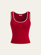 A fitted red ribbed knit tank top with white scalloped trim and scoop neckline.
