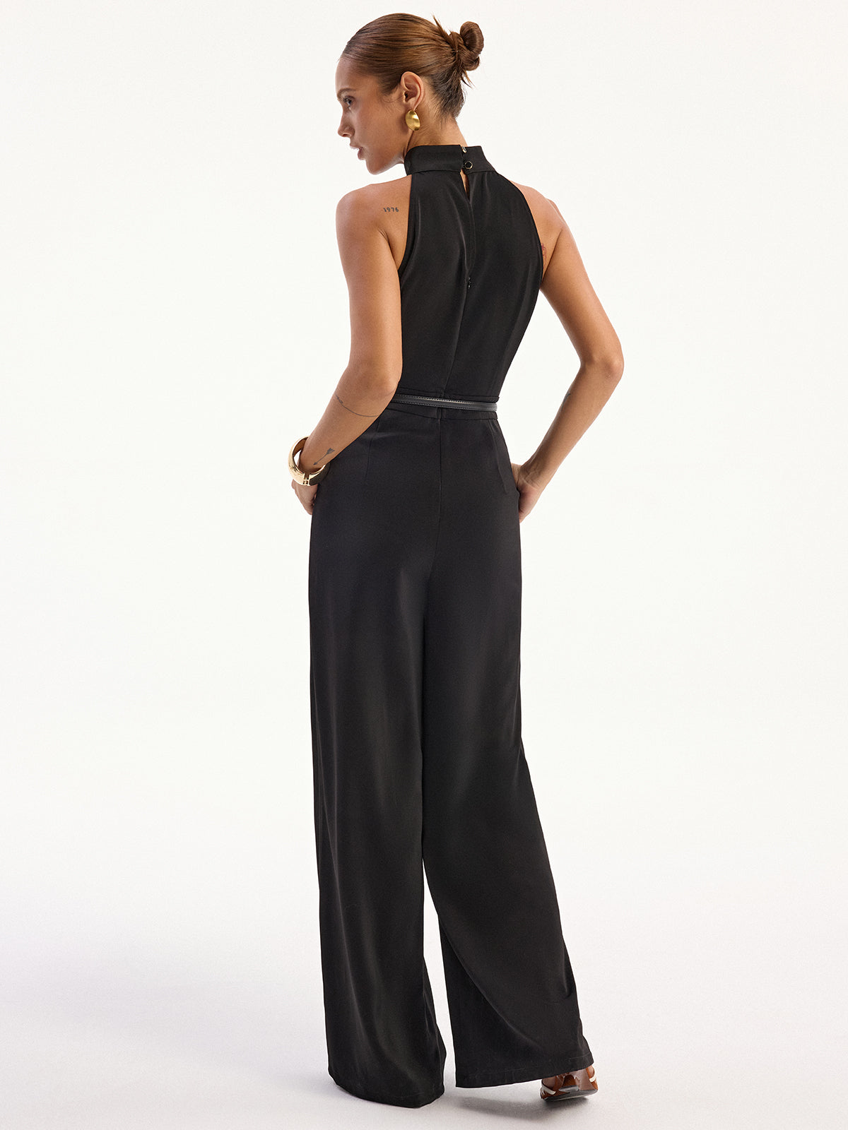 LA FINE FLEUR Satin Halter Neck Jumpsuit featuring a distinctive back slit detail.