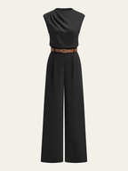 Sleek sleeveless mock neck jumpsuit with wide legs and a brown belt with gold buckle.