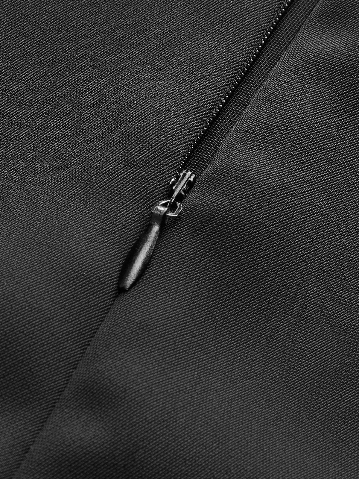 Close-up of black zipper on LA FINE FLEUR mock neck jumpsuit with wide legs.