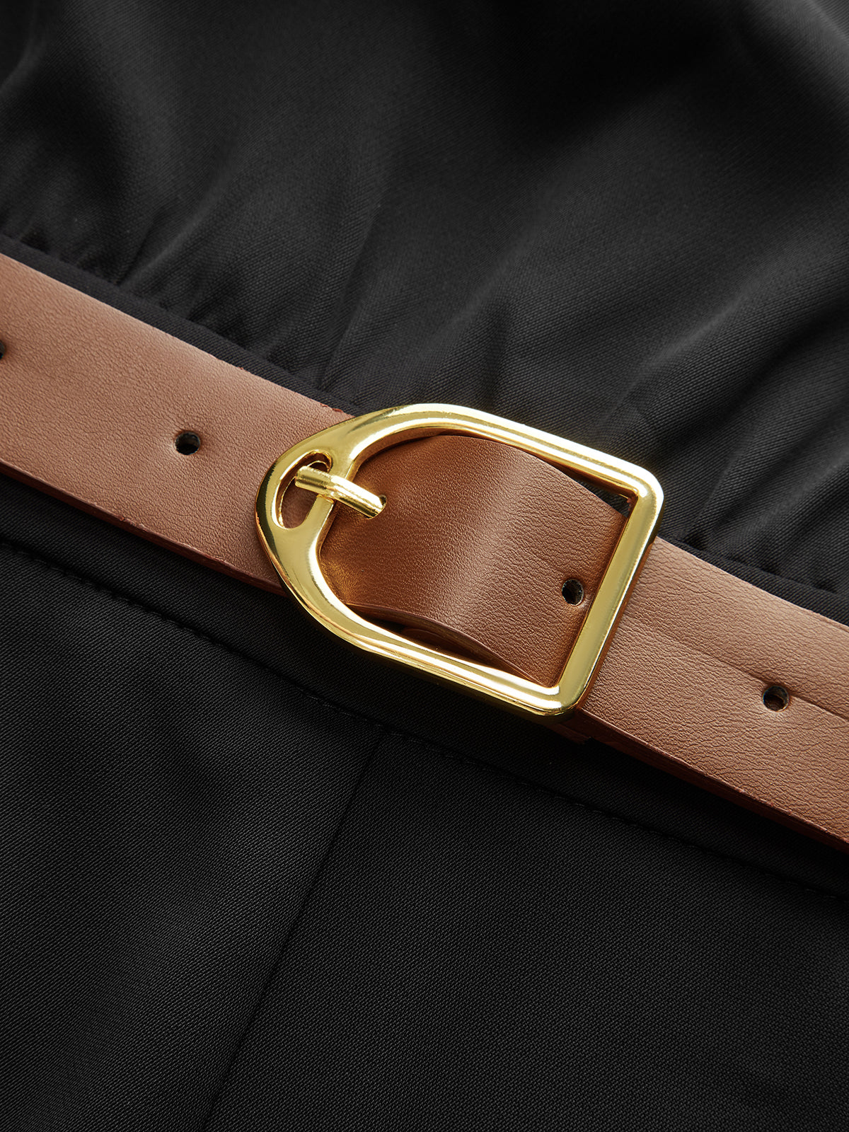 Black mock neck jumpsuit with wide legs and brown leather belt featuring gold buckle.