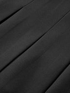 Black LA FINE FLEUR pleated mini skirt with decorative buttons, diagonal lines, and highlighted folds.