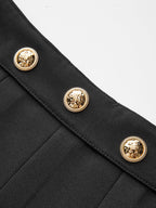 Black pleated mini skirt with three gold, embossed buttons featuring rope-like borders.