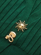 Dark green ribbed knit vest with metallic detail and cap sleeves, featuring gold pins.