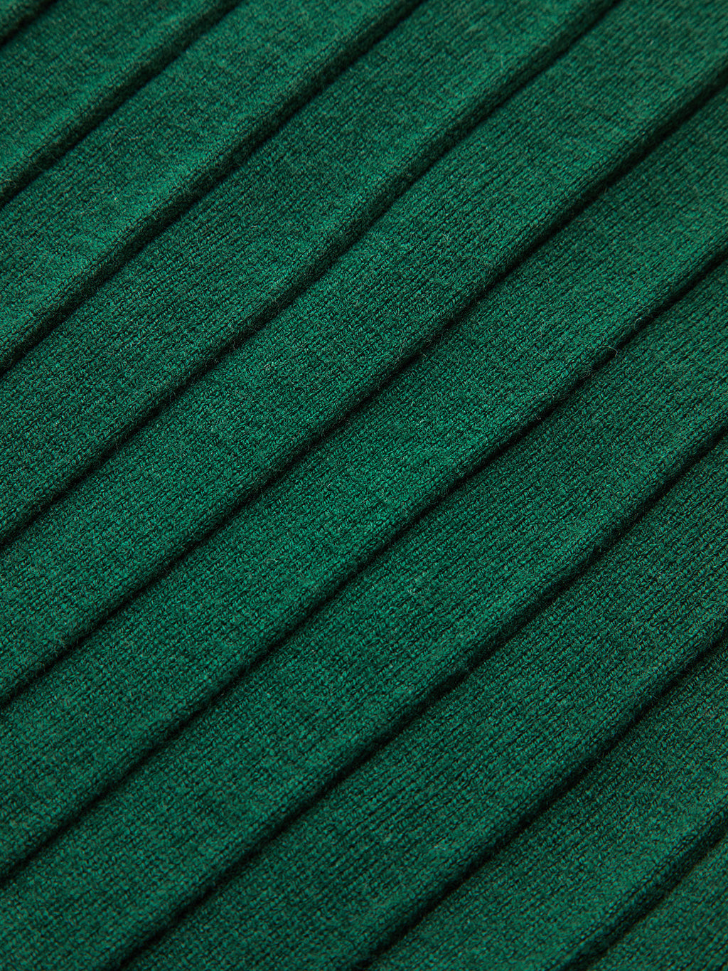 Green ribbed knit vest with diagonal raised lines and subtle metallic accents on cap sleeves.